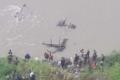 The mangled remains of the bus in the Trishuli river. - Sakshi Post