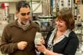 Professor Allen Nutman and Associate Professor Vickie Bennett holding a 3.7 billion year old rock containing stromatolite. - Sakshi Post