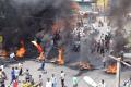 Violent mobs burnt vehicles and disrupted traffic in Bengaluru on Monday. - Sakshi Post