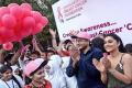 Dr P Raghu Ram and actress Regina Cassandra participating in the Pink Ribbon walk held at KBR park - Sakshi Post