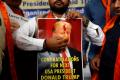 A Trump poster is adorned with Tilak and offered laddu by Donald Trump supporters in India. - Sakshi Post