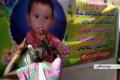 A relative grieving at the poster of the boy put up in Iduluru village. - Sakshi Post