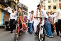 BJP’s Atul Shah (right) and Shaina NC (left) riding bicycles as part of their campaign for the civic polls in Mumbai. - Sakshi Post