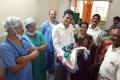 Collector with his grand daughter at Mulugu govt hospital - Sakshi Post