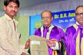 Satyam Babu receives his graduation certificate in Hyderabad on Monday. - Sakshi Post