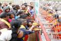 Volunteers distributing prasadam to devotees in the queue lines in Tirumala. - Sakshi Post