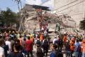 People look for survivors in a collapsed building after an earthquake struck - Sakshi Post