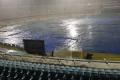 Uppal stadium covered with polythene sheets as sudden downpour lashed Hyderabad on Thursday night. - Sakshi Post