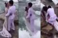 The newly wedded couple stood on rock, close to the sea, to pose for pictures without anticipating the shocking turn of events - Sakshi Post