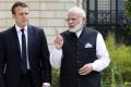 Indian Prime Minister Narendra Modi (R) speaks with French President Emmanuel Macron&amp;amp;nbsp; - Sakshi Post