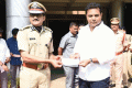 TRS leader KT Rama Rao handing over the cheque to IGP Raju - Sakshi Post