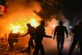 Police personnel attempt to douse a burning vehicle torched allegedly by protestors during a rally against CAA in Daryaganj, New Delhi on Friday.&amp;amp;nbsp; - Sakshi Post