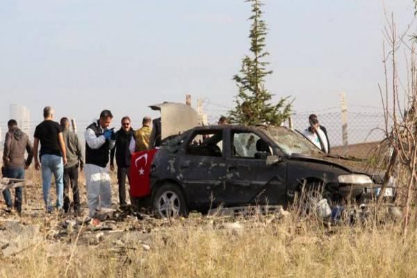 Forensic experts examining the car used by suicide bombers. - Sakshi Post