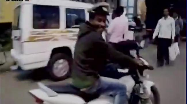 The drunk man was seen riding a police two-wheeler vehicle in a haphazard manner. A passer-by tried to capture a video of the drunk man on his mobile phone. - Sakshi Post