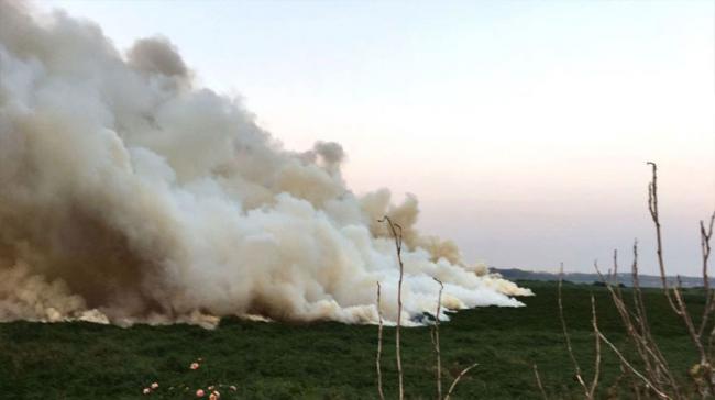 Huge clouds of smoke billowing from the lake replete with sewage, chemical effluents and construction debris - Sakshi Post